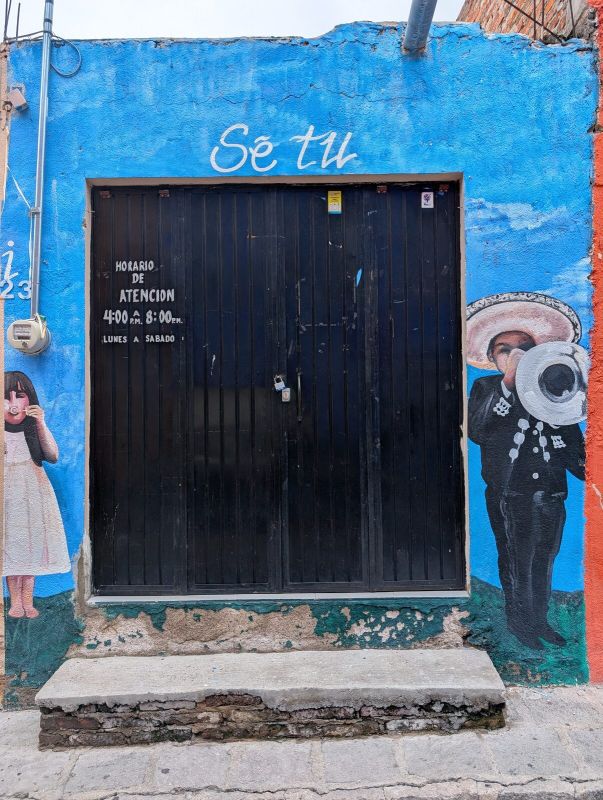 Mariachi and girl by door