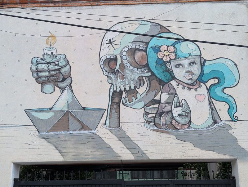 Child, skull, and paper boat
