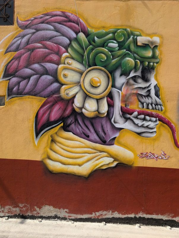 Plumed skull deity