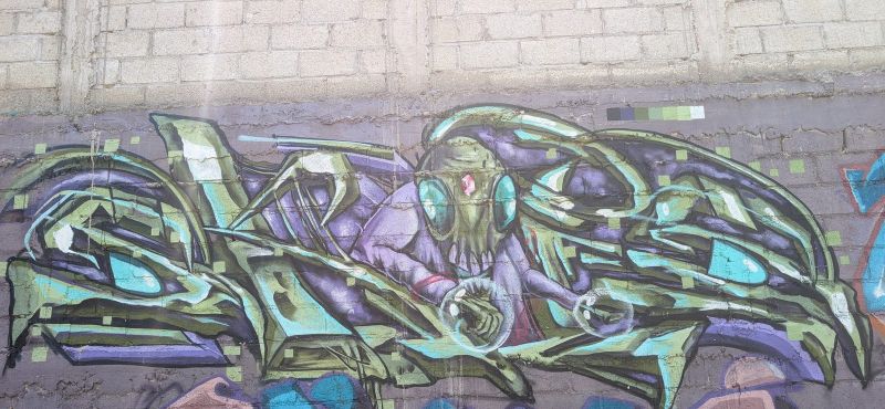 Fanged creature in letters