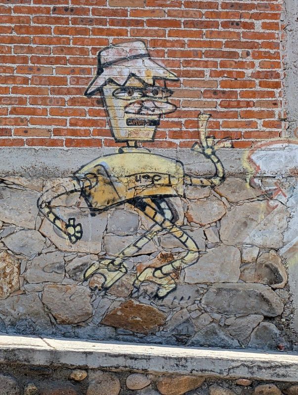 Long-limbed figure in a hat