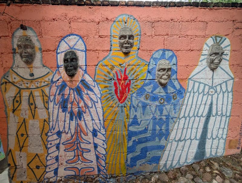 Robed masked figures